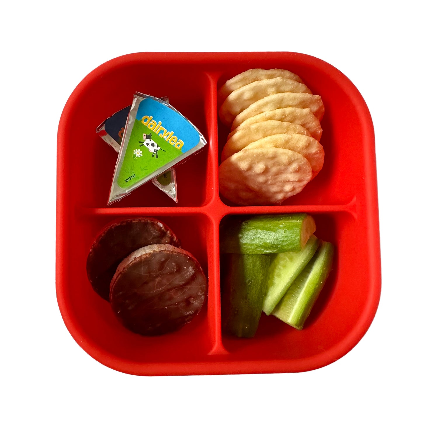 a red silicone compartment snack box filled with crackers, dairylea triangles, chocolate covered rice crackers and cucumber batons.