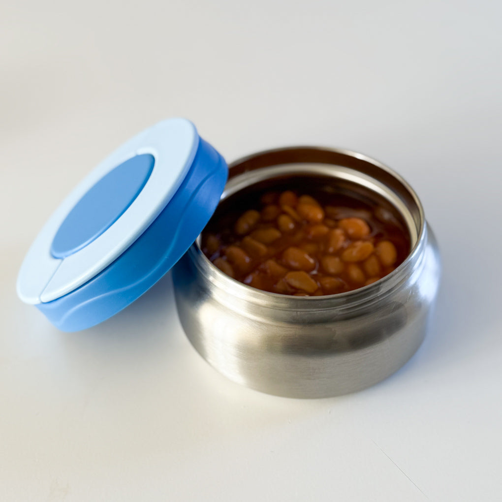Small stainless steel food thermos with a blue lid containing baked beans.