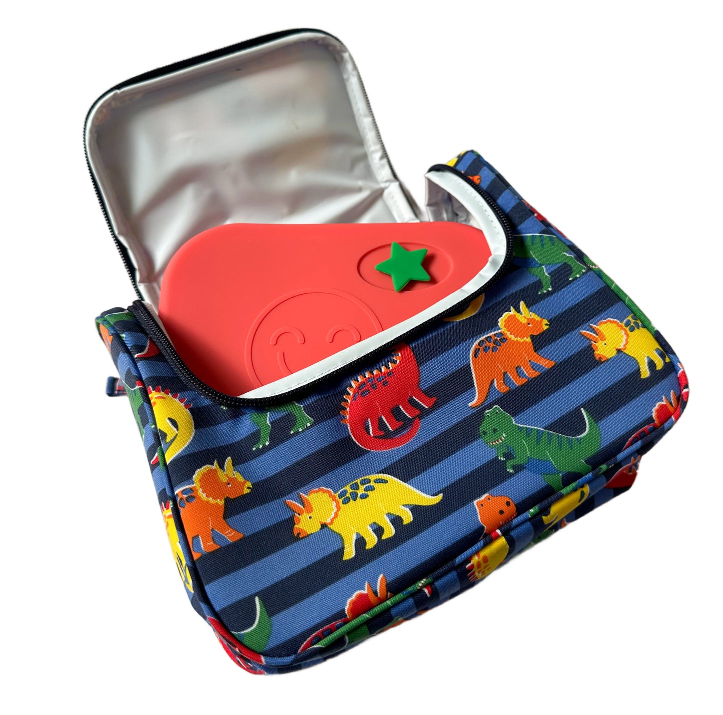 a red silicone lunchbox with green star stopper in a blue dinosaur themed lunch bag.