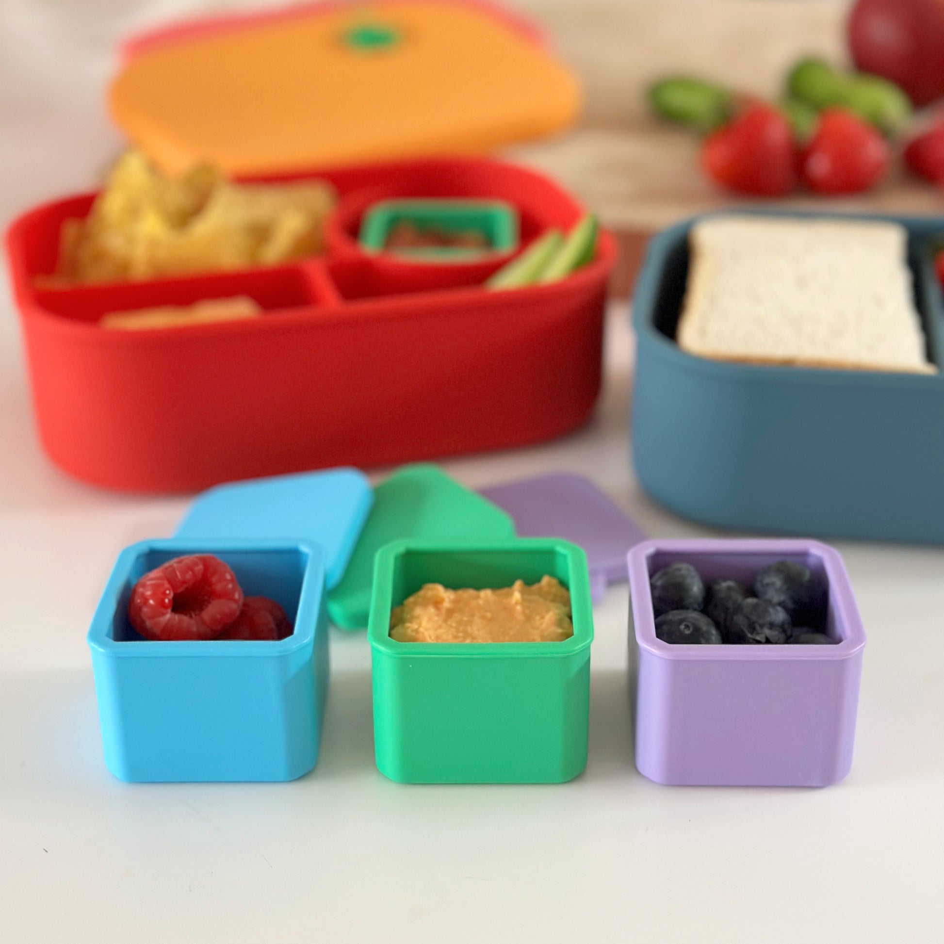 3 silicone dip & sauce containers in blue, green and purple.