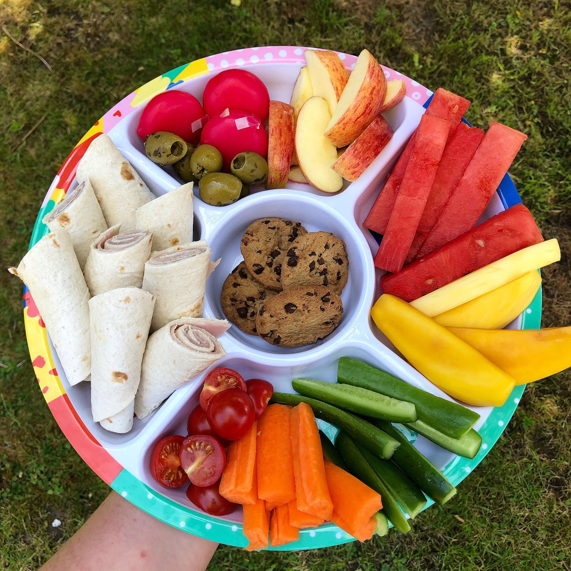 The Biggie Divided Plate For Kids filled with a variety of snacks, wraps and fresh fruit and veggies.