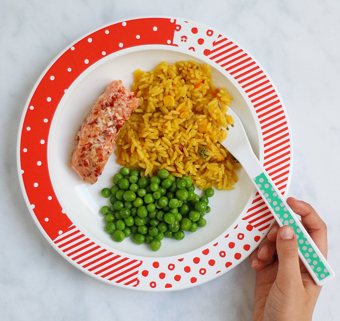 Kids classic plate with a poertion of vegetable rice, fish and peas.