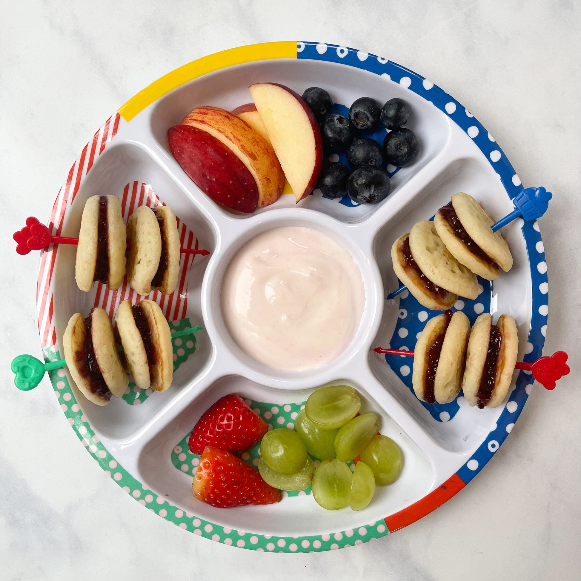 Pick Sticks being used on a Midi Pick Plate with mini pancakes, yogurt and fresh fruit.